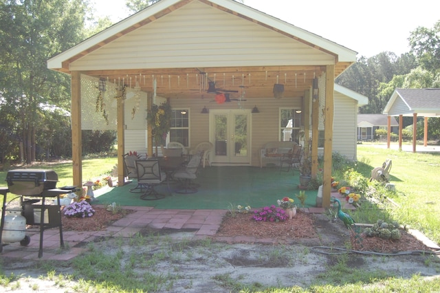 304 S Magnolia Ave, Andrews, SC 29510 - rear view of house featuring ceiling fan, french doors, a lawn, and a patio area