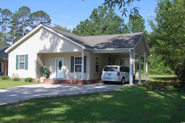 304 S Magnolia Ave, Andrews, SC 29510 - view of front facade with concrete driveway, a carport, a front yard, and roof with shingles