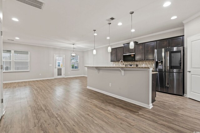 148 Long Leaf Pine Dr, Conway, SC 29526 - kitchen with stainless steel fridge with ice dispenser, backsplash, dark brown cabinetry, recessed lighting, and an island with sink