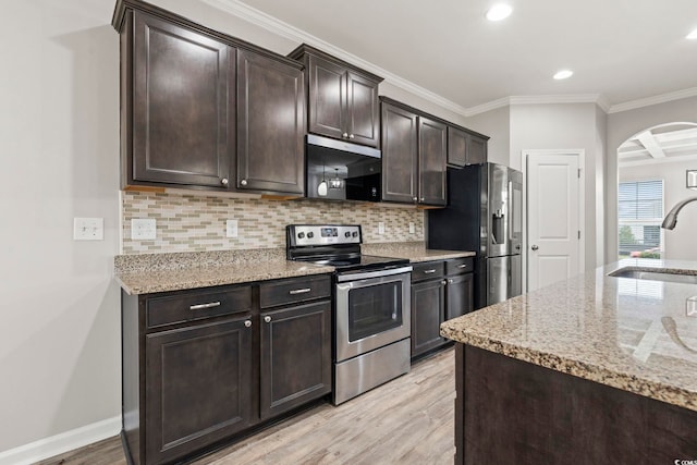 148 Long Leaf Pine Dr, Conway, SC 29526 - kitchen featuring appliances with stainless steel finishes, a sink, arched walkways, light wood-style flooring, and backsplash