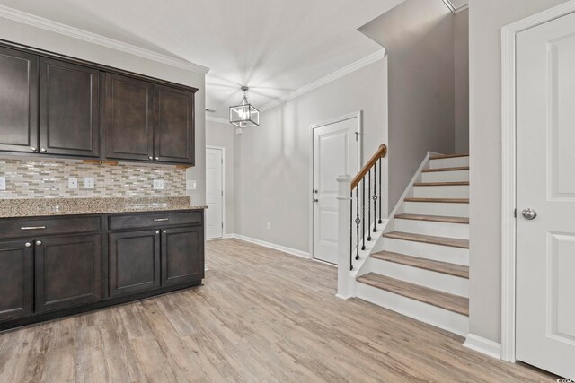 148 Long Leaf Pine Dr, Conway, SC 29526 - kitchen with dark brown cabinets, light wood-style floors, baseboards, light stone countertops, and backsplash
