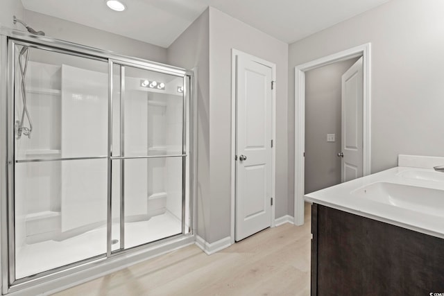 148 Long Leaf Pine Dr, Conway, SC 29526 - bathroom with wood finished floors, a shower stall, baseboards, double vanity, and recessed lighting