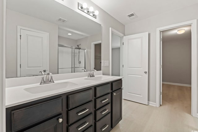 148 Long Leaf Pine Dr, Conway, SC 29526 - full bath with wood finished floors, double vanity, a stall shower, and baseboards