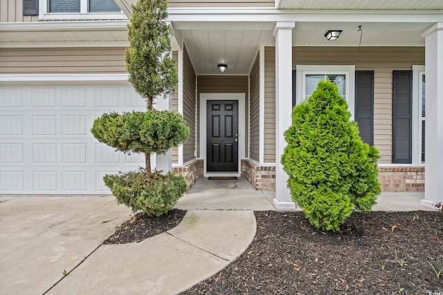 148 Long Leaf Pine Dr, Conway, SC 29526 - doorway to property featuring a garage, stone siding, covered porch, and concrete driveway