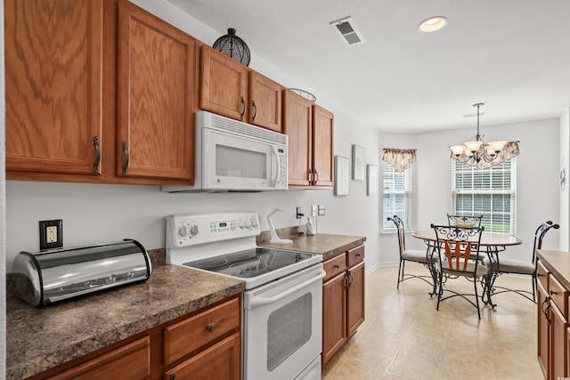 2448 Whetstone Ln, Myrtle Beach, SC 29579 - kitchen featuring white appliances, brown cabinetry, dark countertops, a chandelier, and baseboards