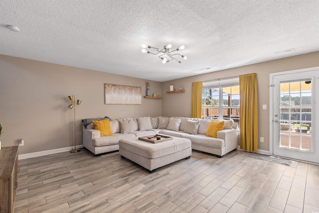 104 Clovis Cir, Myrtle Beach, SC 29579 - living area with light wood-style flooring, a textured ceiling, a chandelier, and baseboards