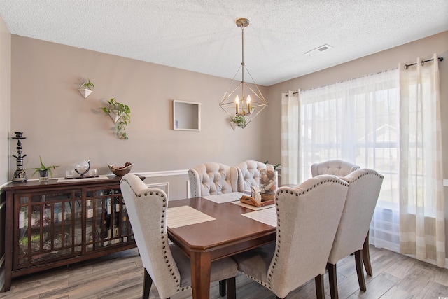 104 Clovis Cir, Myrtle Beach, SC 29579 - dining area featuring a chandelier, a textured ceiling, and light wood-style floors