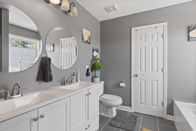 104 Clovis Cir, Myrtle Beach, SC 29579 - full bath with double vanity, toilet, a tub, tile patterned flooring, and a textured ceiling