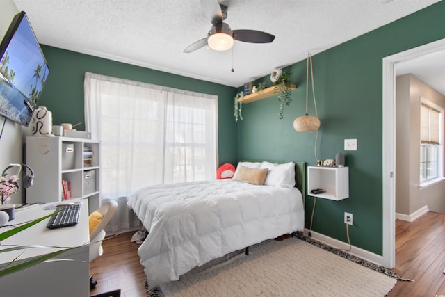104 Clovis Cir, Myrtle Beach, SC 29579 - bedroom featuring multiple windows, wood finished floors, baseboards, and a textured ceiling
