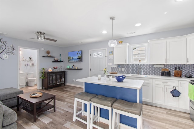 104 Clovis Cir, Myrtle Beach, SC 29579 - kitchen with light countertops, backsplash, white cabinets, ceiling fan, and recessed lighting
