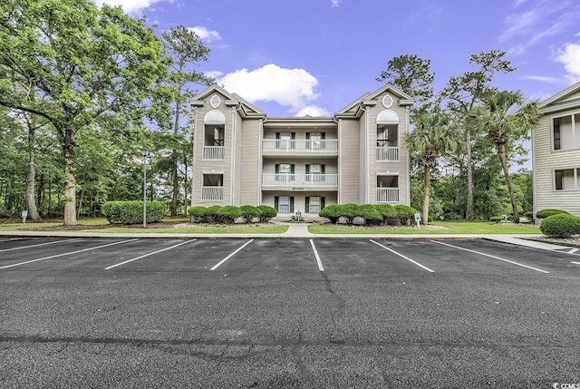 598 Blue Stem Dr Unit 52E, Pawleys Island, SC 29585 - view of building exterior with uncovered parking
