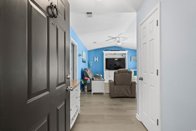 502 Garden Dr, Surfside Beach, SC 29575 - hall with lofted ceiling, light wood-type flooring, and a textured ceiling