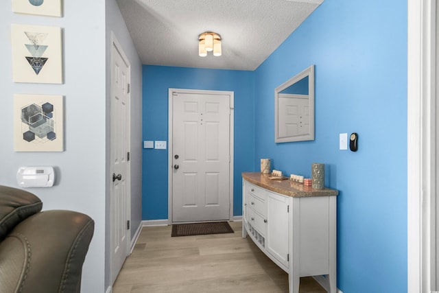 502 Garden Dr, Surfside Beach, SC 29575 - entryway featuring light wood-style floors, baseboards, and a textured ceiling