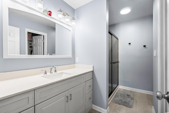 502 Garden Dr, Surfside Beach, SC 29575 - full bath featuring wood finished floors, vanity, a stall shower, and baseboards