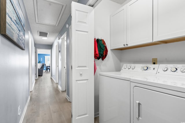 502 Garden Dr, Surfside Beach, SC 29575 - laundry area with cabinet space, washer and dryer, light wood finished floors, and baseboards