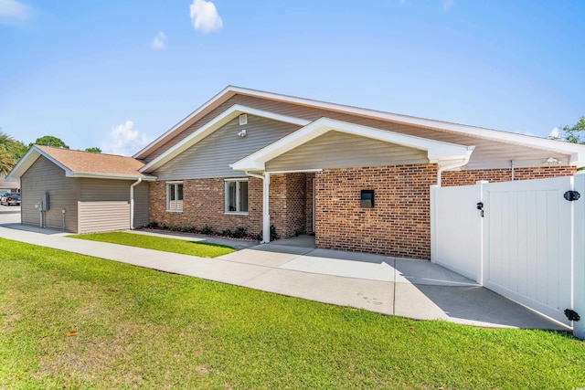 502 Garden Dr, Surfside Beach, SC 29575 - ranch-style home featuring brick siding and a gate