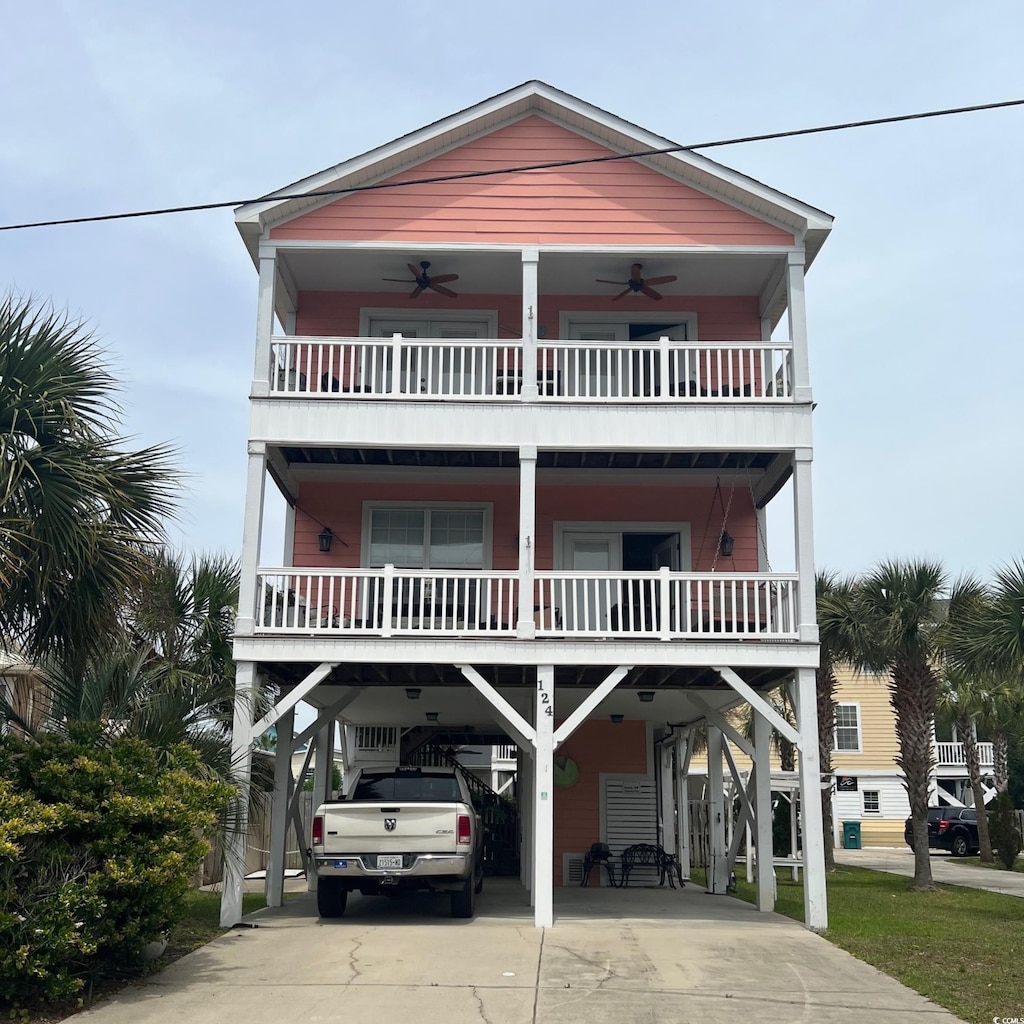 124 Rainbow Dr, Murrells Inlet, SC 29576 - coastal home featuring a carport, a ceiling fan, driveway, and a balcony