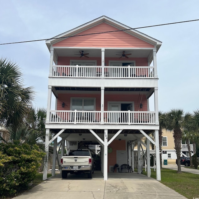 124 Rainbow Dr, Murrells Inlet, SC 29576 - coastal home featuring a carport, a ceiling fan, driveway, and a balcony