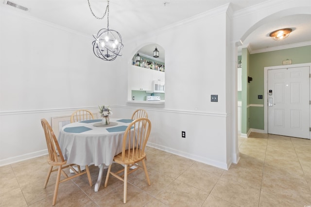 5825 Catalina Dr Unit 124, North Myrtle Beach, SC 29582 - dining room with arched walkways, ornamental molding, a chandelier, and light tile patterned floors