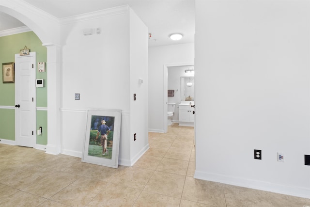 5825 Catalina Dr Unit 124, North Myrtle Beach, SC 29582 - unfurnished living room with arched walkways, light tile patterned floors, ornamental molding, and baseboards