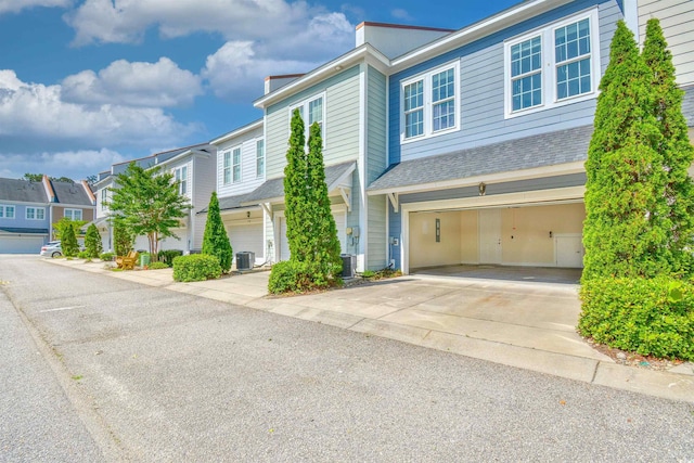 750 Shine Ave Unit 750, Myrtle Beach, SC 29577 - multi unit property with concrete driveway, an attached garage, central AC unit, a residential view, and a shingled roof