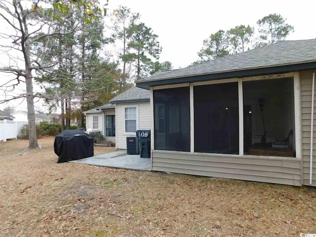 6805 Creekwatch Rd Unit 105, Myrtle Beach, SC 29588 - back of property featuring a shingled roof, a patio, and a sunroom