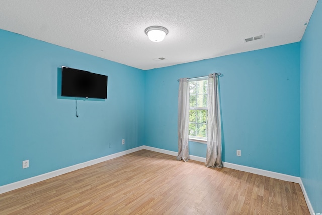1033 Mccall Loop, Conway, SC 29526 - unfurnished room featuring a textured ceiling, light wood-type flooring, and baseboards