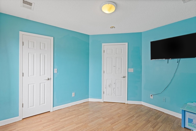 1033 Mccall Loop, Conway, SC 29526 - unfurnished bedroom with wood finished floors, baseboards, and a textured ceiling