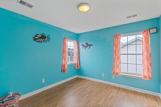 1033 Mccall Loop, Conway, SC 29526 - empty room with a textured ceiling, wood finished floors, and baseboards