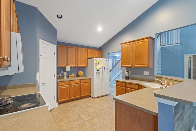 1033 Mccall Loop, Conway, SC 29526 - kitchen featuring white refrigerator with ice dispenser, a sink, a peninsula, range, and brown cabinets