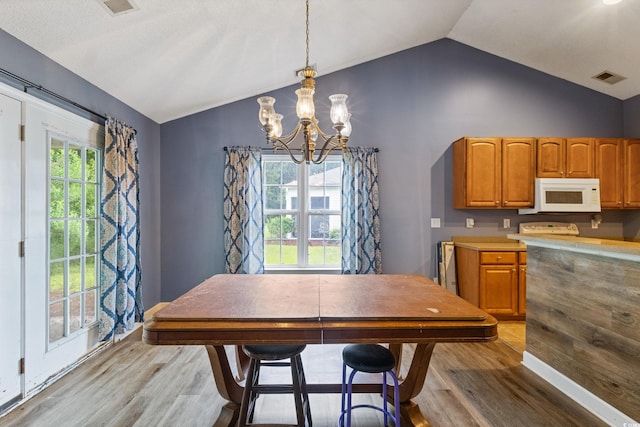 1033 Mccall Loop, Conway, SC 29526 - dining area featuring light wood-type flooring, lofted ceiling, a chandelier, and plenty of natural light