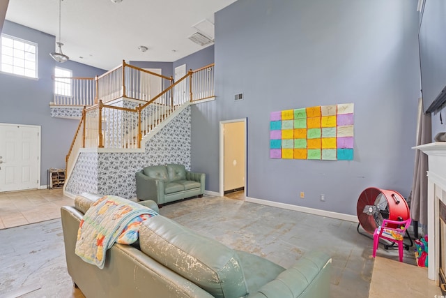 1033 Mccall Loop, Conway, SC 29526 - living room featuring a towering ceiling, stairway, and baseboards