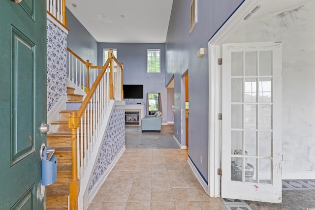 1033 Mccall Loop, Conway, SC 29526 - foyer entrance featuring stairway, a glass covered fireplace, baseboards, and light tile patterned floors