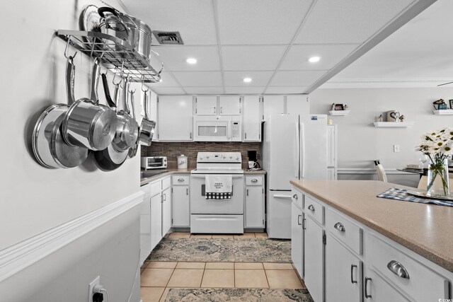 1210 N Waccamaw Dr Unit 1105, Murrells Inlet, SC 29576 - kitchen with white appliances, recessed lighting, white cabinets, light tile patterned floors, and backsplash