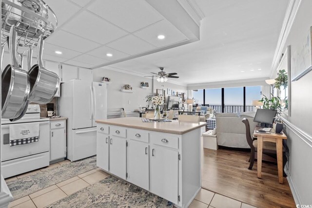 1210 N Waccamaw Dr Unit 1105, Murrells Inlet, SC 29576 - kitchen with white appliances, a ceiling fan, crown molding, light countertops, and light tile patterned flooring