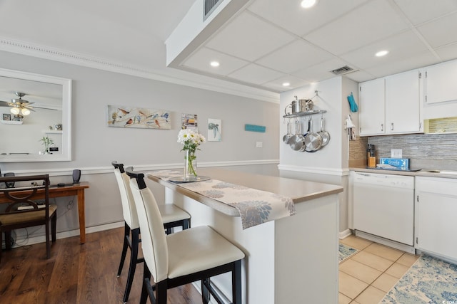1210 N Waccamaw Dr Unit 1105, Murrells Inlet, SC 29576 - kitchen with dishwasher, tasteful backsplash, recessed lighting, a kitchen bar, and light countertops