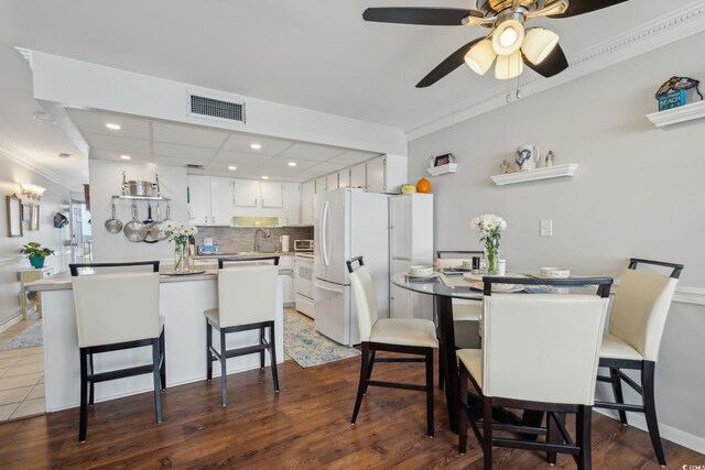 1210 N Waccamaw Dr Unit 1105, Murrells Inlet, SC 29576 - dining room featuring ornamental molding, ceiling fan, recessed lighting, and dark wood-style flooring