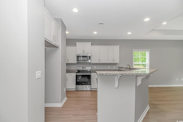 3539 Harrelson Ave, Loris, SC 29569 - kitchen featuring appliances with stainless steel finishes, baseboards, light wood-style flooring, and recessed lighting