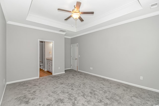 3539 Harrelson Ave, Loris, SC 29569 - unfurnished bedroom with a raised ceiling, carpet flooring, crown molding, baseboards, and connected bathroom