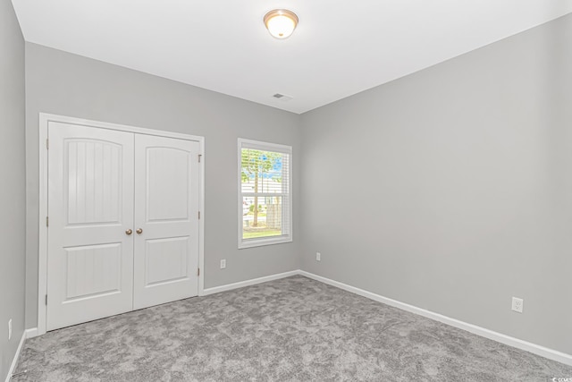 3539 Harrelson Ave, Loris, SC 29569 - unfurnished bedroom with carpet floors, baseboards, and a closet