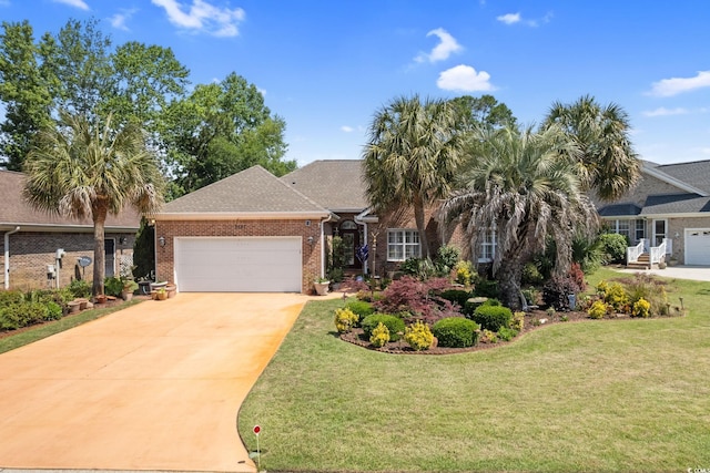 2567 Lake Vista Dr, Little River, SC 29566 - view of front of home featuring an attached garage, concrete driveway, brick siding, and a front yard