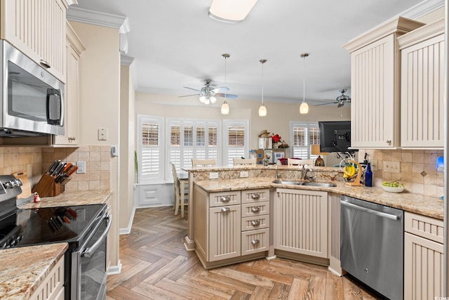 2567 Lake Vista Dr, Little River, SC 29566 - kitchen featuring stainless steel appliances, ceiling fan, a peninsula, crown molding, and a sink