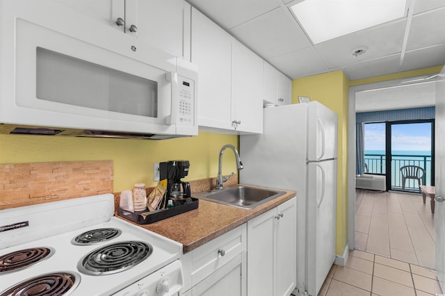 2207 S Ocean Blvd Unit 1517, Myrtle Beach, SC 29577 - kitchen featuring white appliances, a sink, light tile patterned floors, and white cabinets