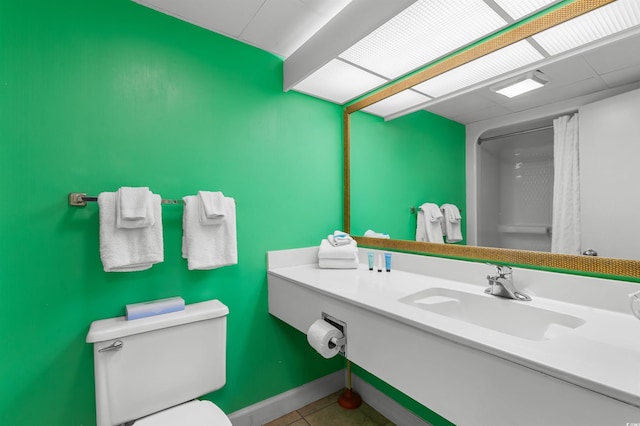 2207 S Ocean Blvd Unit 1517, Myrtle Beach, SC 29577 - full bath with toilet, vanity, tile patterned flooring, curtained shower, and baseboards