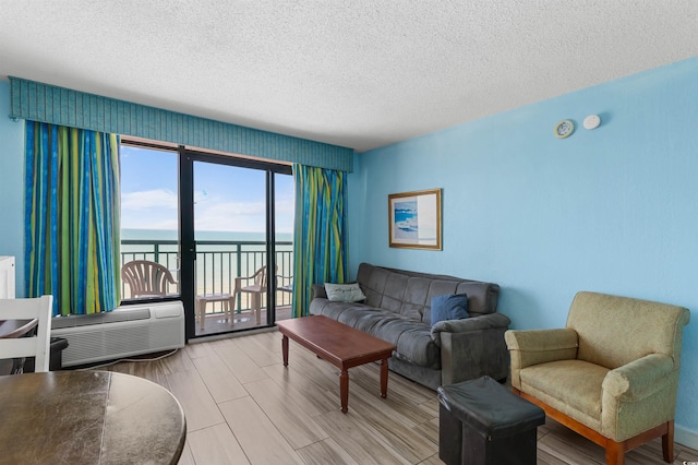 2207 S Ocean Blvd Unit 1517, Myrtle Beach, SC 29577 - living room with a water view, a textured ceiling, and light wood finished floors