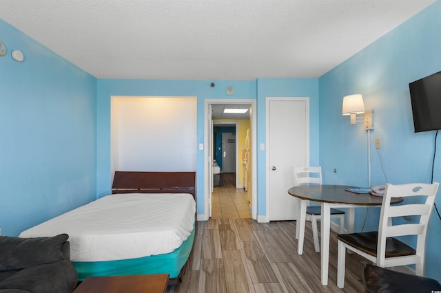 2207 S Ocean Blvd Unit 1517, Myrtle Beach, SC 29577 - bedroom featuring wood finished floors and a textured ceiling