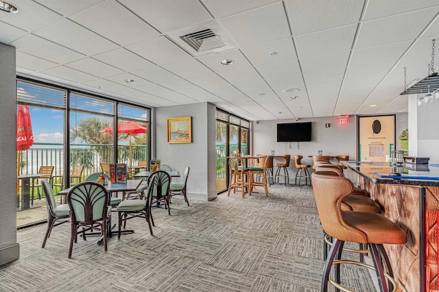 2207 S Ocean Blvd Unit 1517, Myrtle Beach, SC 29577 - carpeted dining space featuring a paneled ceiling, a dry bar, and floor to ceiling windows