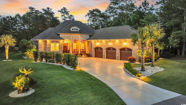 81 Cascade Dr, Murrells Inlet, SC 29576 - french country inspired facade featuring a garage, driveway, a front lawn, and brick siding