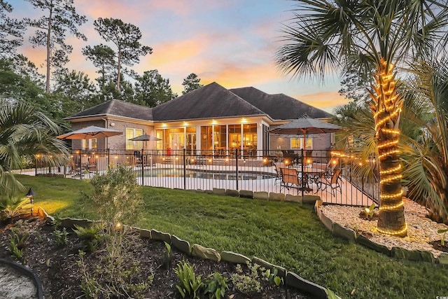 81 Cascade Dr, Murrells Inlet, SC 29576 - back of property at dusk with a patio area