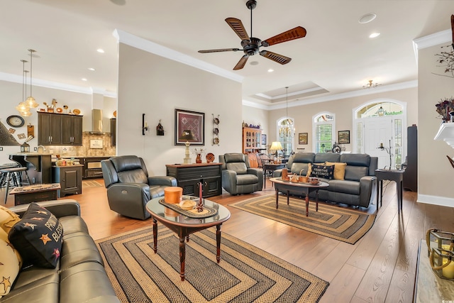 81 Cascade Dr, Murrells Inlet, SC 29576 - living room featuring a ceiling fan, wood finished floors, ornamental molding, recessed lighting, and a tray ceiling